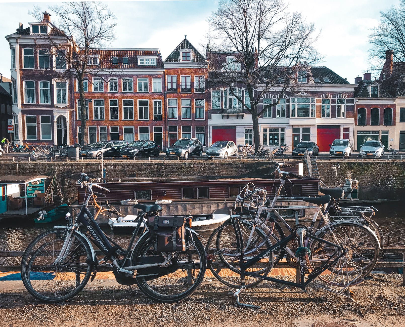 bicycles parked beside brown wooden fence near a river