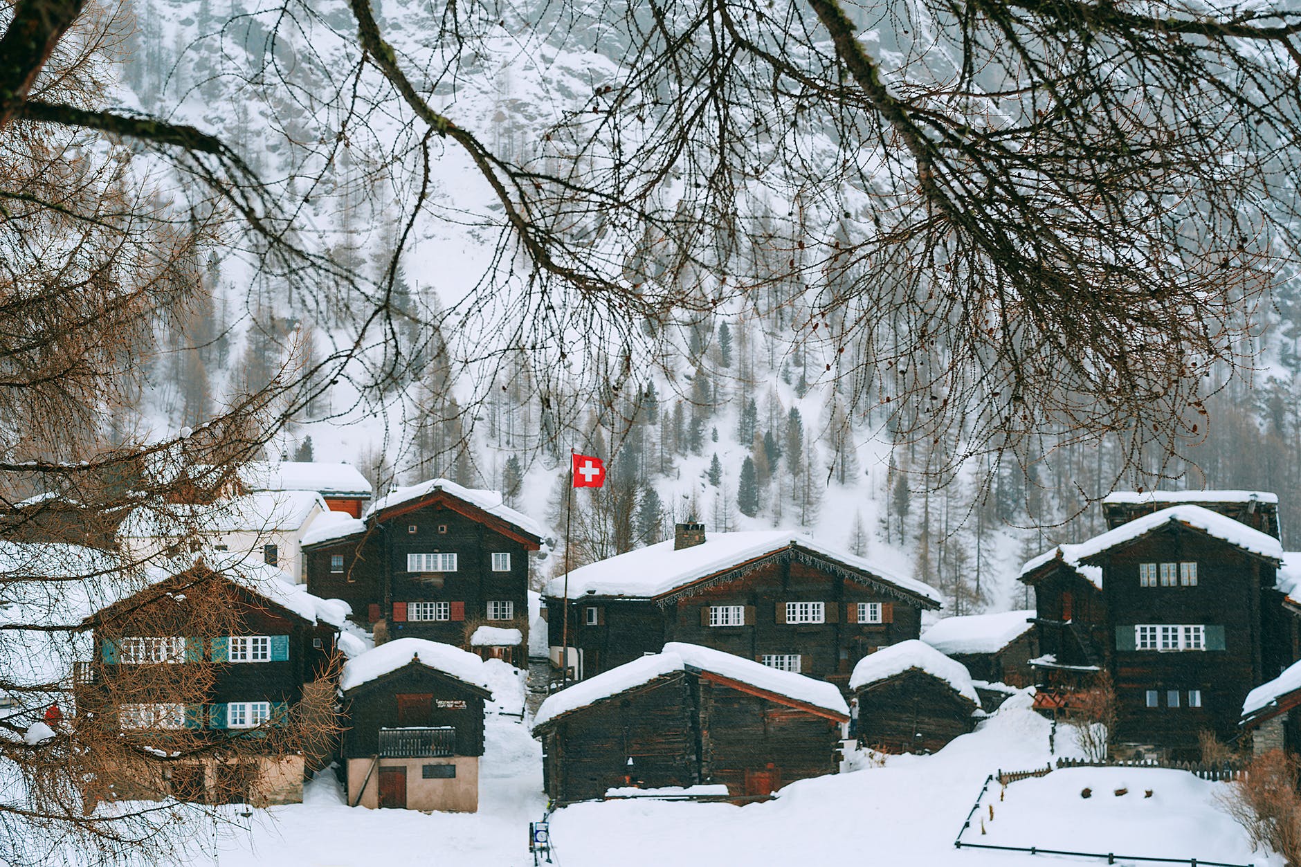 snowy village houses on hilly terrain